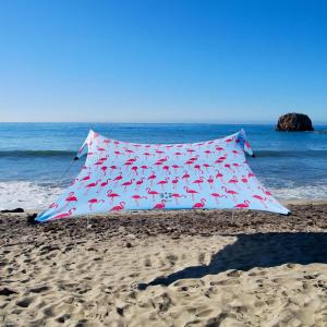 imageNeso Gigante  Portable Beach Tent  Ideal to Enjoy with Family and Friends  UPF 50 WaterResistant and Lightweight  Aqua Fronds 11 x 11Flamingos